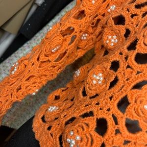 Orange crochet sweater with pearl embellishments